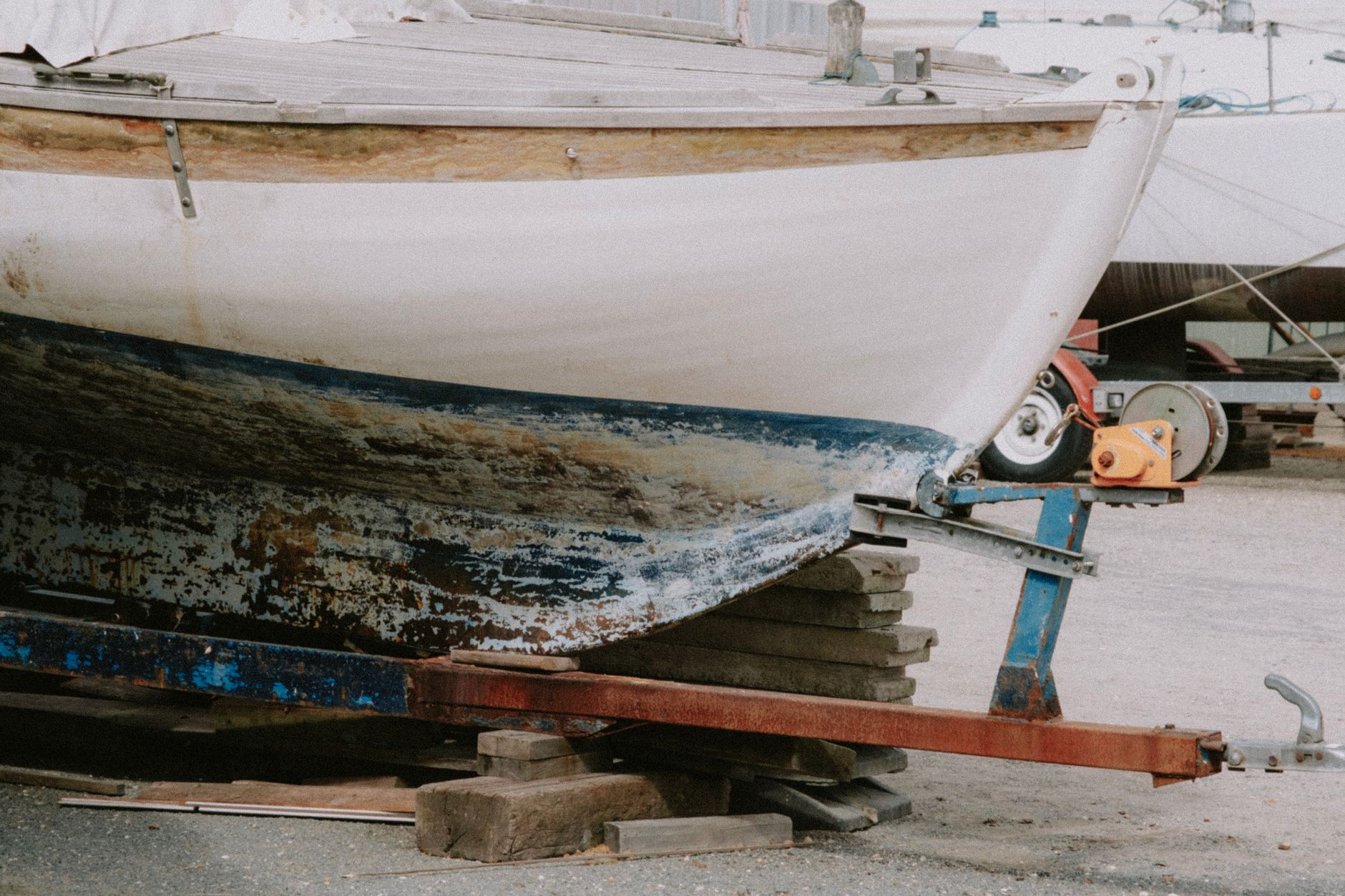 Close-up of traditional tar waterline coating on a North Yorkshire fishing boat hull showing historic boat paint method